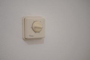 a light switch on a wall with a mirror at Agriturismo Col Moschin in Grosseto