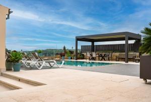 a patio with a gazebo and a swimming pool at Moli De Can Cristan in Muro
