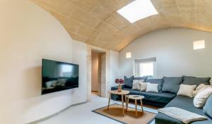 a living room with a couch and a tv at Moli De Can Cristan in Muro
