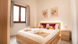 a bedroom with a large bed with two towels on it at Moli De Can Cristan in Muro +31 photos