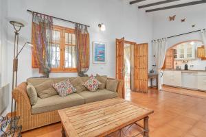 a living room with a couch and a table at Casa Oliana in Cómpeta