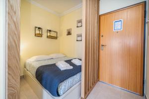 a small bedroom with a bed and a door at Aqua Studio in Portimão +18 photos