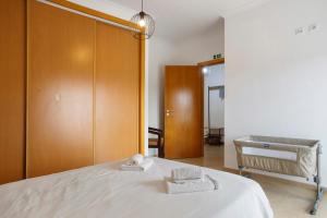 a bedroom with a bed with two towels on it at A O - Tina House Ferrel in Ferrel