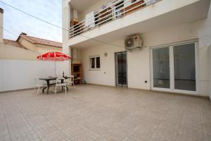 a patio with a table and chairs and an umbrella at A O - Tina House Ferrel in Ferrel