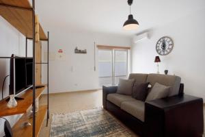 a living room with a couch and a clock on the wall at A O - Tina House Ferrel in Ferrel