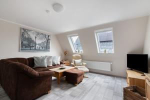 a living room with a couch and a tv at Ferienwohnung Janina in Norddeich