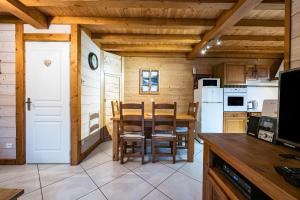 a kitchen with a table and chairs in a room at Chalet La Petite Maison in Saint-Marcel +20 photos