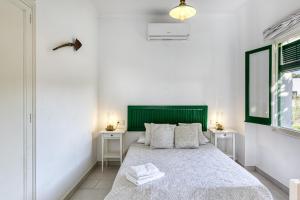 a bedroom with a large bed with two night stands at Masia Cal Ros in S'agaro +37 photos