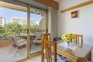 a dining room with a table and chairs on a balcony at Jardín X in Gandía