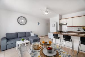 a living room with a couch and a table at Sunset Lux Las Floritas in Arona