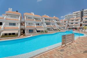 a large apartment complex with a large swimming pool at Sunset Lux Las Floritas in Arona
