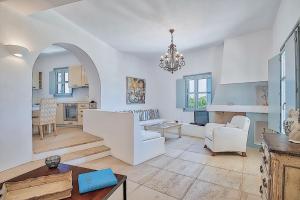 a large white living room with a table and chairs at Villa Afroditi A in Antiparos