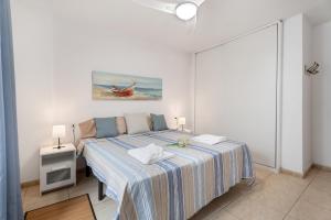 a bedroom with a bed and a painting on the wall at Sunset Lux Las Floritas in Arona