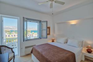 a bedroom with a bed and a large window at Villa Afroditi A in Antiparos