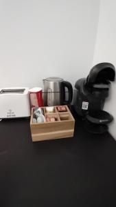 a table with a coffee pot and a box of food at Studio Despoina in Skala Kallonis