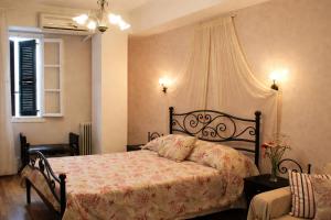 a bedroom with a bed and a window at Filyra Pension in Nafplio