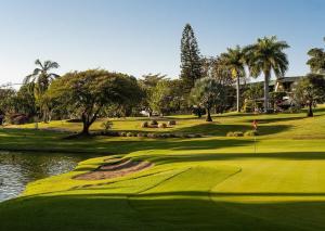 a view of a golf course with a pond and a green at Villa Marines Cuernavaca in Cuernavaca