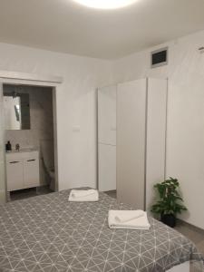 a room with a bed with two towels on it at Lorber house Štinjan - Studio in Pula +22 photos