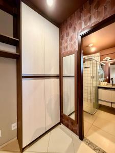 a walk in closet with a glass door in a kitchen at Central Duplex Loft Near USP in São Carlos +10 photos