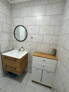 a bathroom with a sink and a mirror at NV Apartments in Volodymyr-Volynskyi