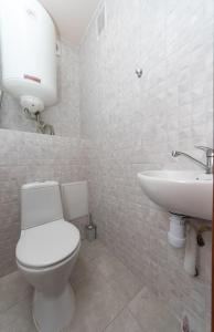a bathroom with a toilet and a sink at Apartment near VDNG 18010 in Kyiv +7 photos