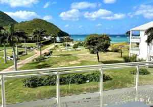 a view of the ocean from a balcony at Le Domaine Anse Marcel Beach Resort in Anse Marcel 