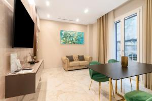 a living room with a table and a couch at Ginex Luxury Suite, Trani in Trani