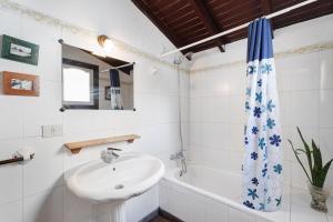 a white bathroom with a sink and a bath tub at Casa Rural El Palmar in Vallehermoso +22 photos