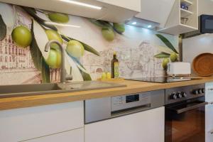 a kitchen with white cabinets and a counter with a sink at Ferienwohnung Sonnenblick in Putbus