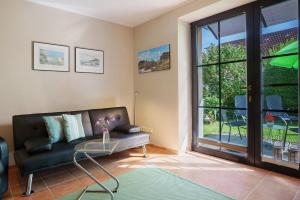 a living room with a couch and a glass table at Ferienwohnung Sonnenblick in Putbus