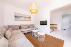 a living room with a couch and a tv at Villa Sion in Cala Mendia