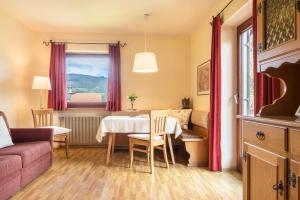 a living room with a table and a couch at Ferienwohnung 3 Vikoler in Vols am Schlern