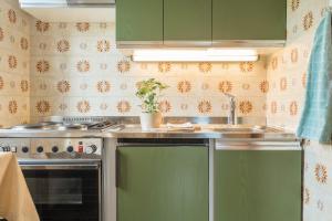 a kitchen with green cabinets and a sink at Ferienwohnung 3 Vikoler in Vols am Schlern +30 photos