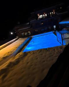 an empty swimming pool in the snow at night at Appartement Soldanelle in La Plagne Tarentaise
