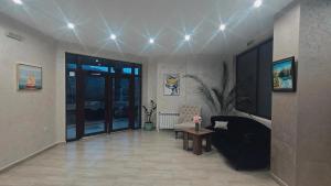 a living room with a couch and a table at Maribel Spa Hotel in Köprilova