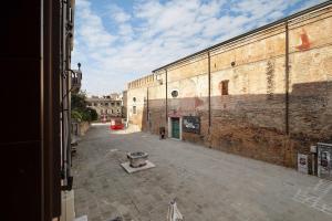 an empty alley in an old brick building at Biennale Apartment near San Marco in Venice