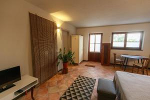 a living room with a bed and a television at Gipsy Rose in Sarzana