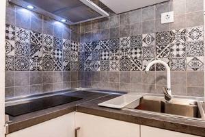 a kitchen with a sink and a counter top at Casa Jimena in Vejer de la Frontera +18 photos