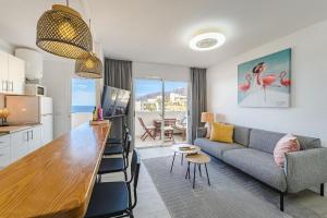 a kitchen and living room with a couch and a table at Playa La Arena 2 Bed Apartment in Puerto de Santiago