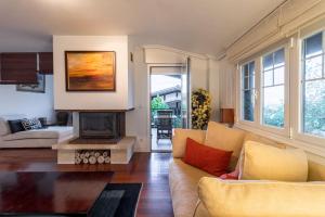 a living room with a couch and a fireplace at Villa La Perla De Sonabia in Oriñón