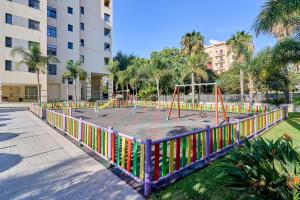 a playground with colorful play equipment in a park at Aptos Turísticos Playa Marinsa in Torre del Mar