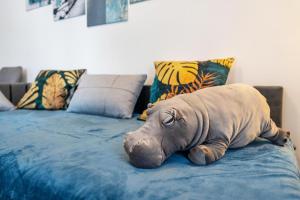 a stuffed dog laying on top of a bed at murihaus Ferienwohnung 2 in Aue