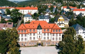 an old building with an orange roof in a town at murihaus Ferienwohnung 2 in Aue