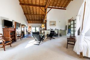 a living room with chairs and a flat screen tv at Le Palmier Exotique - Bazas in Bazas