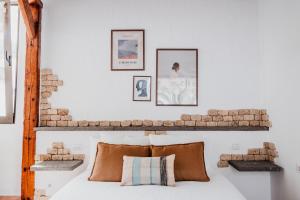 a bedroom with a brick wall and a bed with pillows at Casa Rural Kiko 2 in Icod de los Vinos