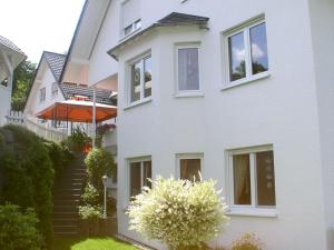 a white house with stairs leading up to it at Ferienhaus Wiese in Olsberg