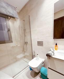 a bathroom with a shower and a toilet and a sink at Studio Al Wahat in Douar el Hafey