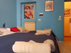 a blue room with a large bed with towels on it at La capannina cilento num 11 in San Marco di Castellabate