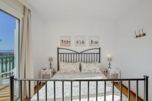 a bedroom with a bed and a balcony at Casa Carmelo in Patalavaca +20 photos