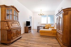 a living room with a large cabinet and a couch at Die Alter Schwede Wohnung 1 in Vechta